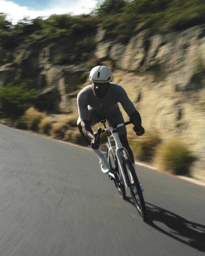 A road cyclist out of the saddle on a mountain pass.